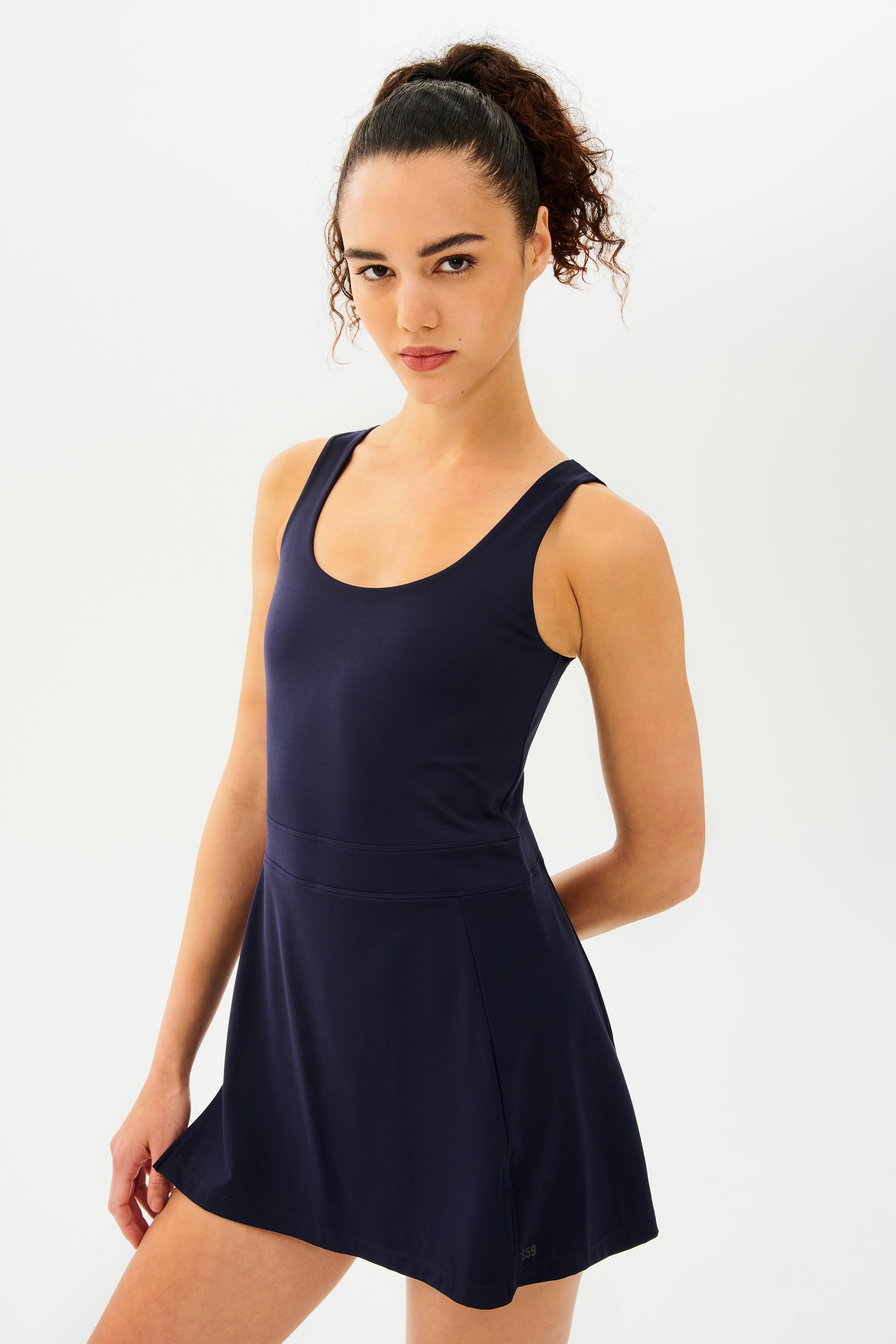 A woman in a navy Martina Rigor Dress - Indigo by SPLITS59 posing for a photo.