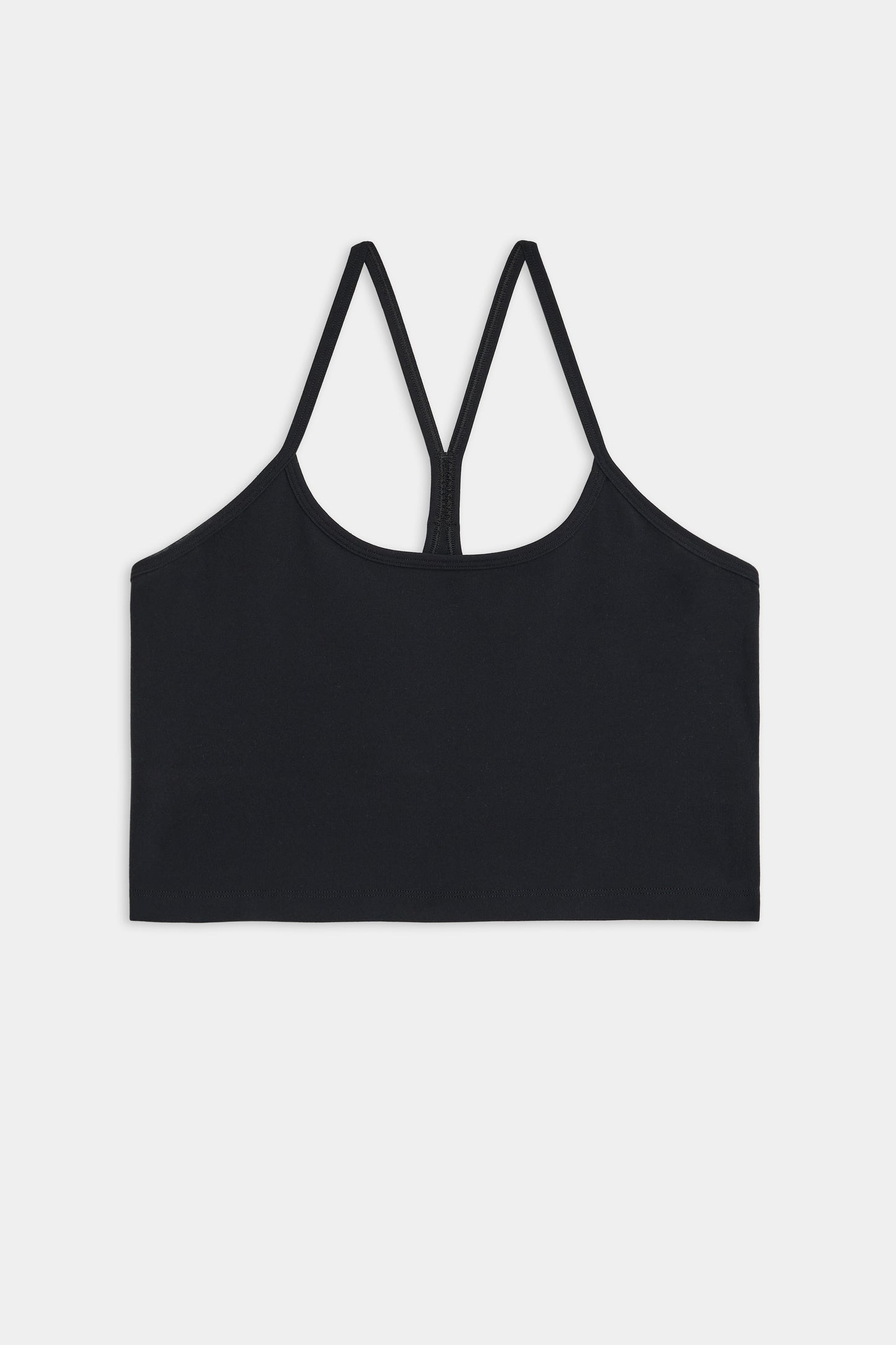 A black, strappy sports bra made from a blend of nylon and spandex, featuring a minimalist design shown against a white background is the **Airweight Crop - Black** by **SPLITS59**.