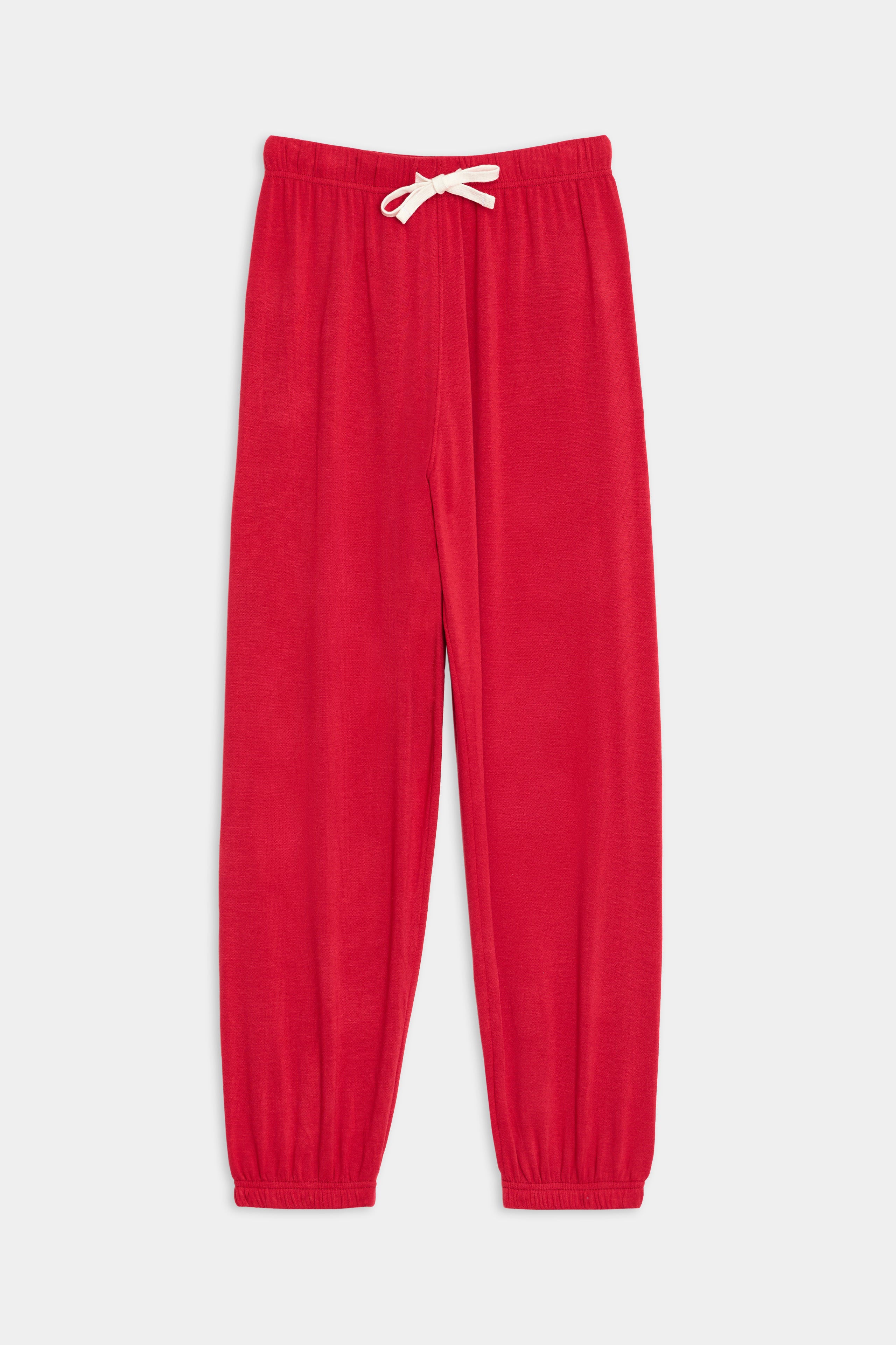 The SPLITS59 Andie Oversized Fleece Sweatpant - Pirate Red, crafted from soft, breathable fabric with an elastic waistband, white drawstring, and elastic cuffs at the ankle, laid out flat on a white background.