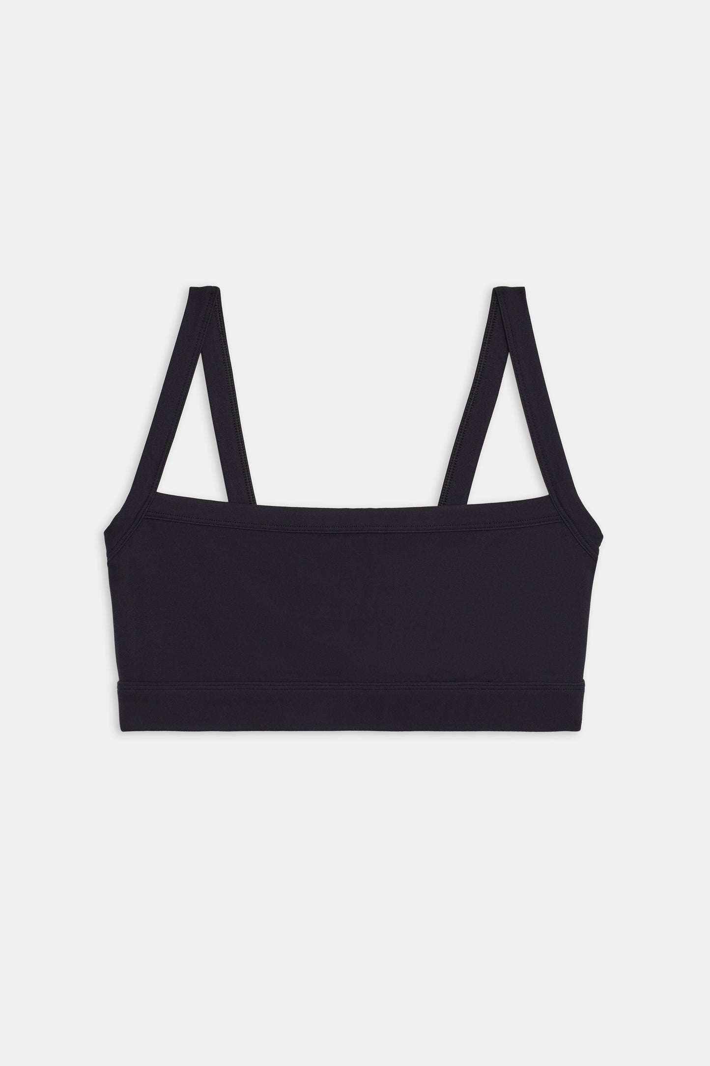 The Monah Rigor Bra - Black by SPLITS59 is a black bralette that features wide straps and exudes a retro sport style from the front view, all set against a plain white background. It's perfect for both workouts and casual wear.