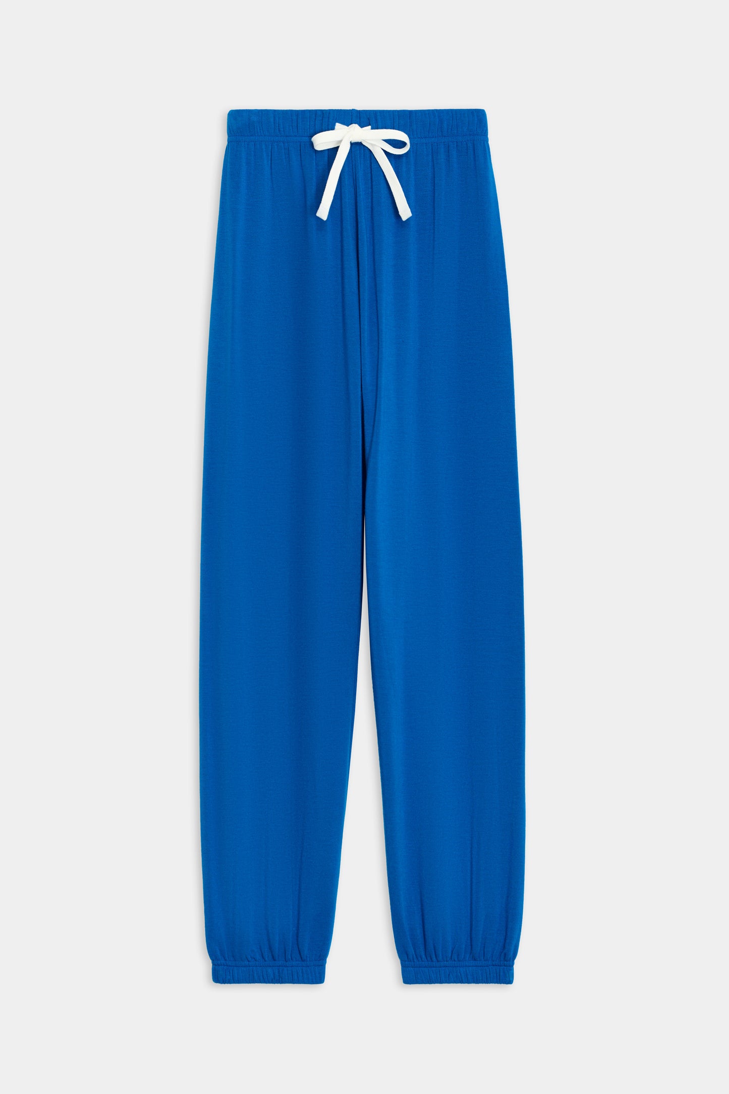 The SPLITS59 Andie Oversized Fleece Sweatpant in Classic Blue is perfect for cool weather workouts, featuring a white drawstring, elastic waistband, ankle cuffs, and is proudly MADE IN LOS ANGELES.